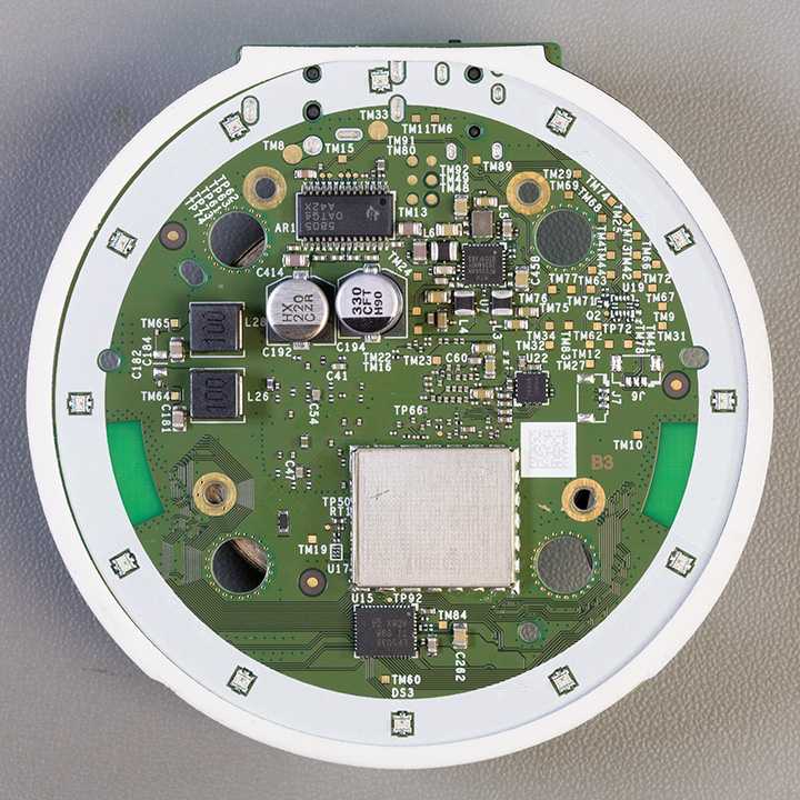 Bottom of the main PCB showing the metal shielding can over the memory chip