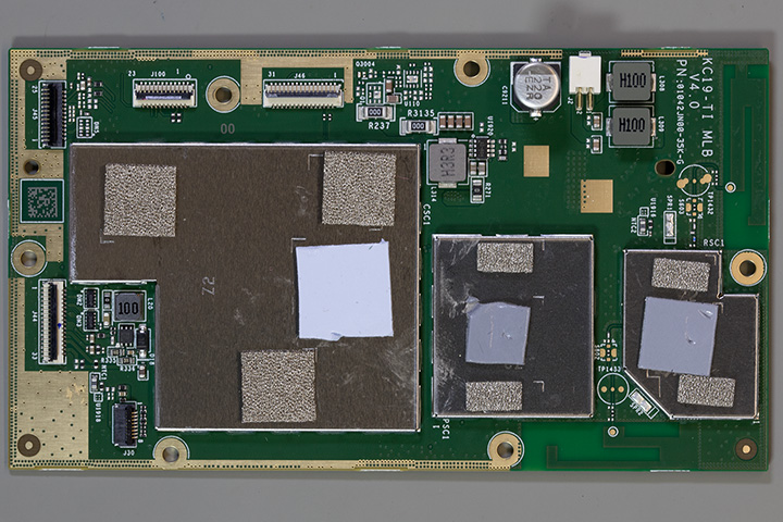 The main PCB with metal shielding over the components