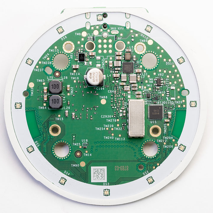 Bottom of the main PCB showing the metal shielding can over the memory chip