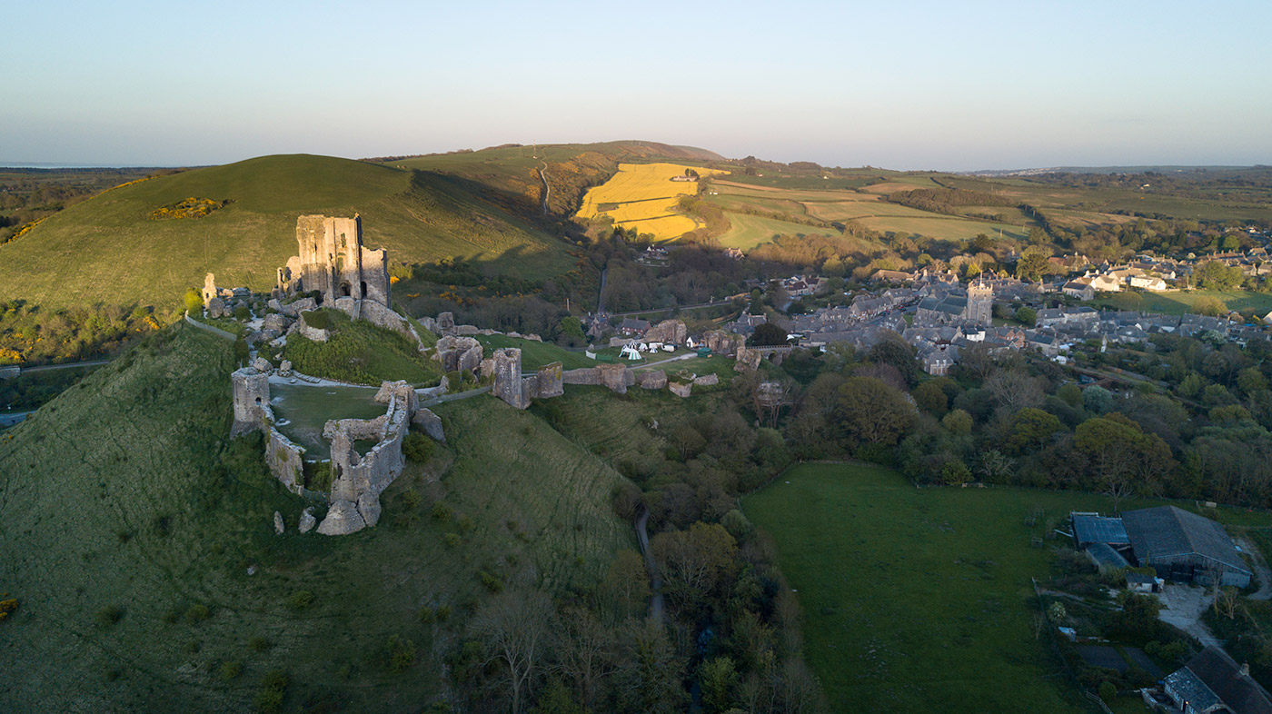 Sun setting over Corfe Castle, looking along the purbeck hills