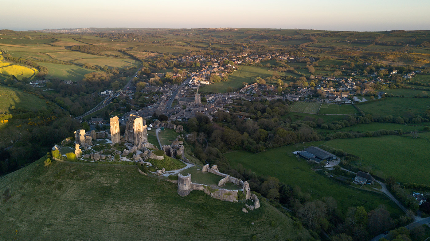 Photo of Sun setting over Corfe Castle, looking along the purbeck hills